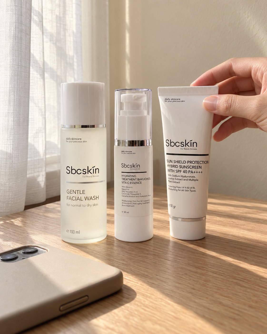 Gentle Facial Wash, Bakuchiol Vita C Essence, dan Sun Shield di meja kayu dekat jendela